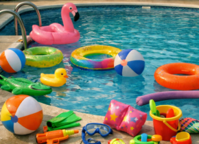 Vibrant kids' pool toys by a blue swimming pool in a sunny backyard, showcasing fun swim lessons for children. Learn more at WD Swim Richmond Hill